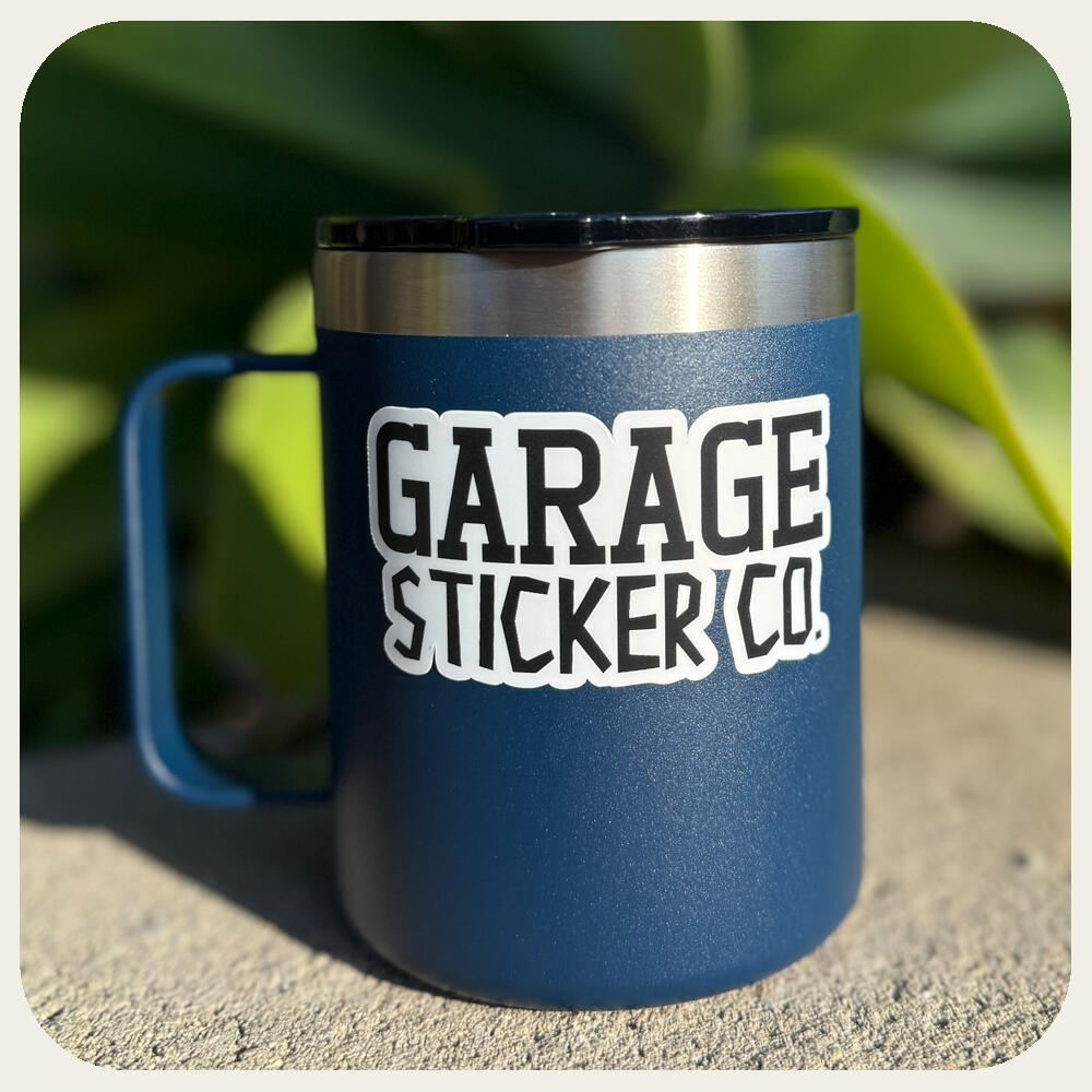 Custom white vinyl decal applied to a blue insulated coffee mug.